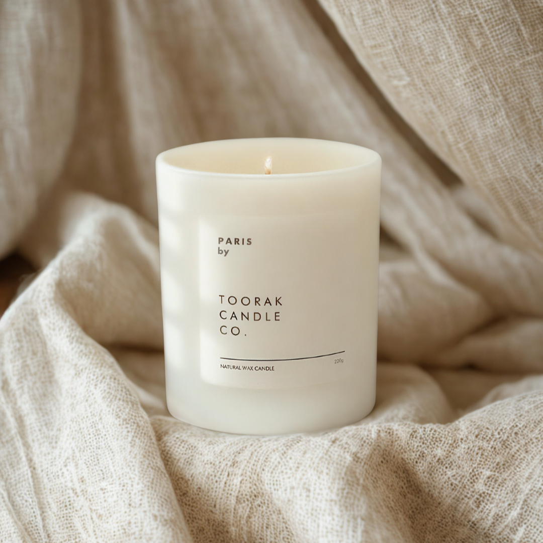 Paris candle on a neutral linen background