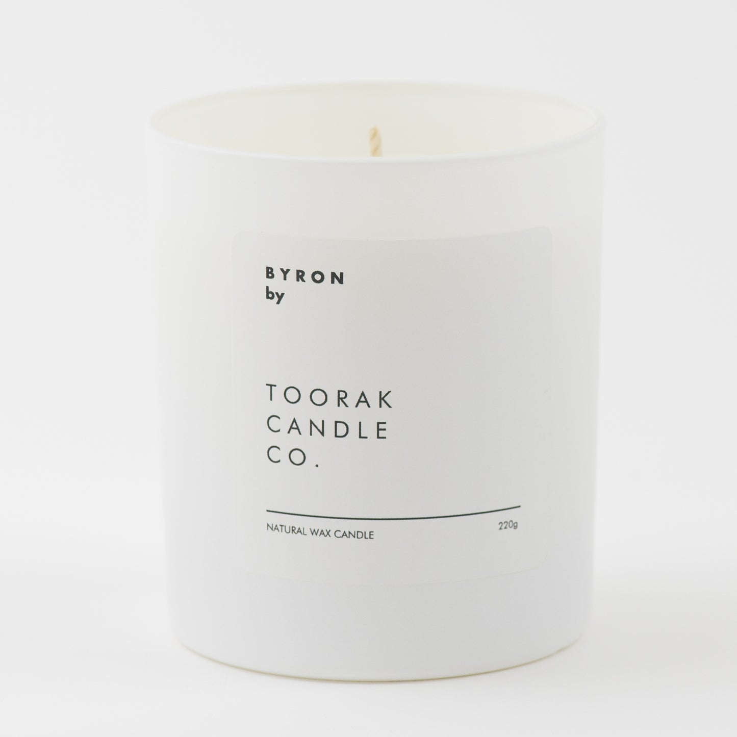 BYRON natural wax candle on plain white background