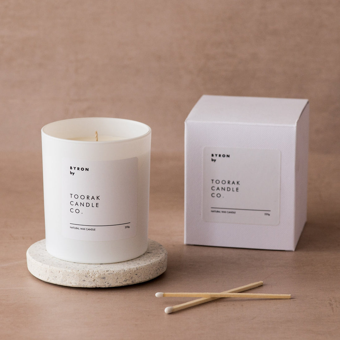 BYRON natural wax luxury candle next to BYRON box