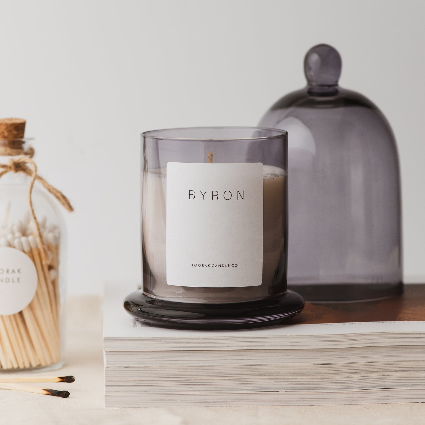 Byron grey cloche candle on books 