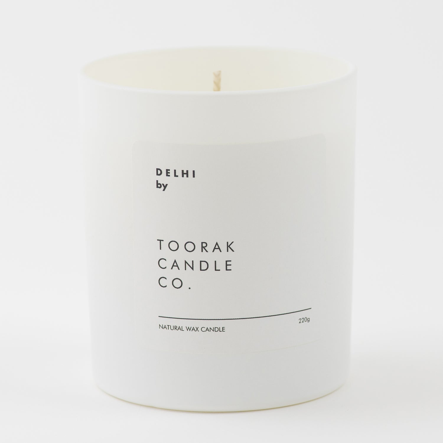 DELHI natural wax candle on plain white background